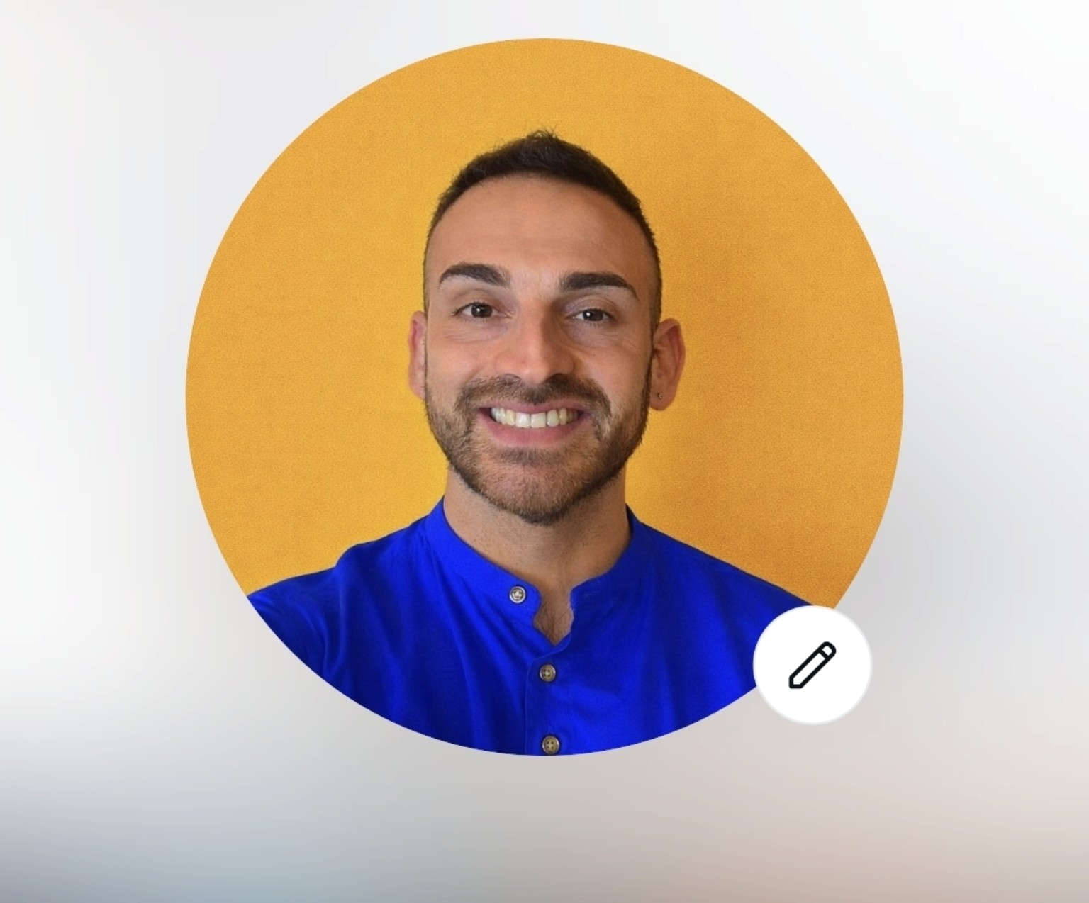 Domenico Russi, sorridente, con camicia blu e sfondo giallo